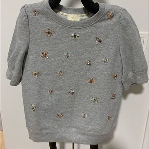 Two Kate spade tops. Grey top is brand new has extra decorations attached to tag